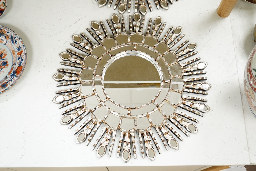 A pair of silver painted sunburst style contemporary wall mirrors, 44cm diameter. Condition - good